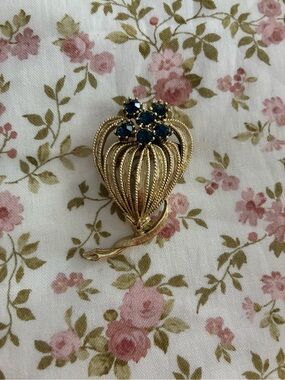 Gold-Tone Floral Brooch with Deep Blue Stones.